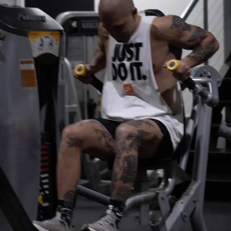 Member seated with dumbbells between sets