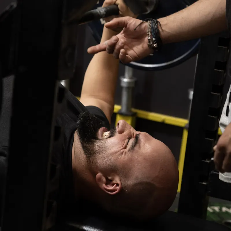 Member bench pressing at Kaos Fitness