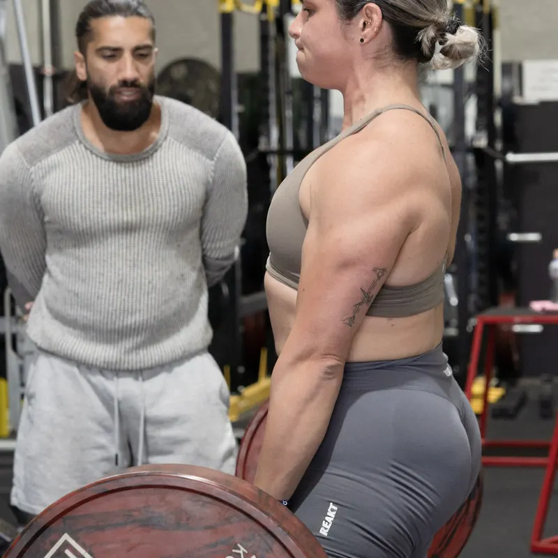 Members loading a barbell at Kaos Fitness