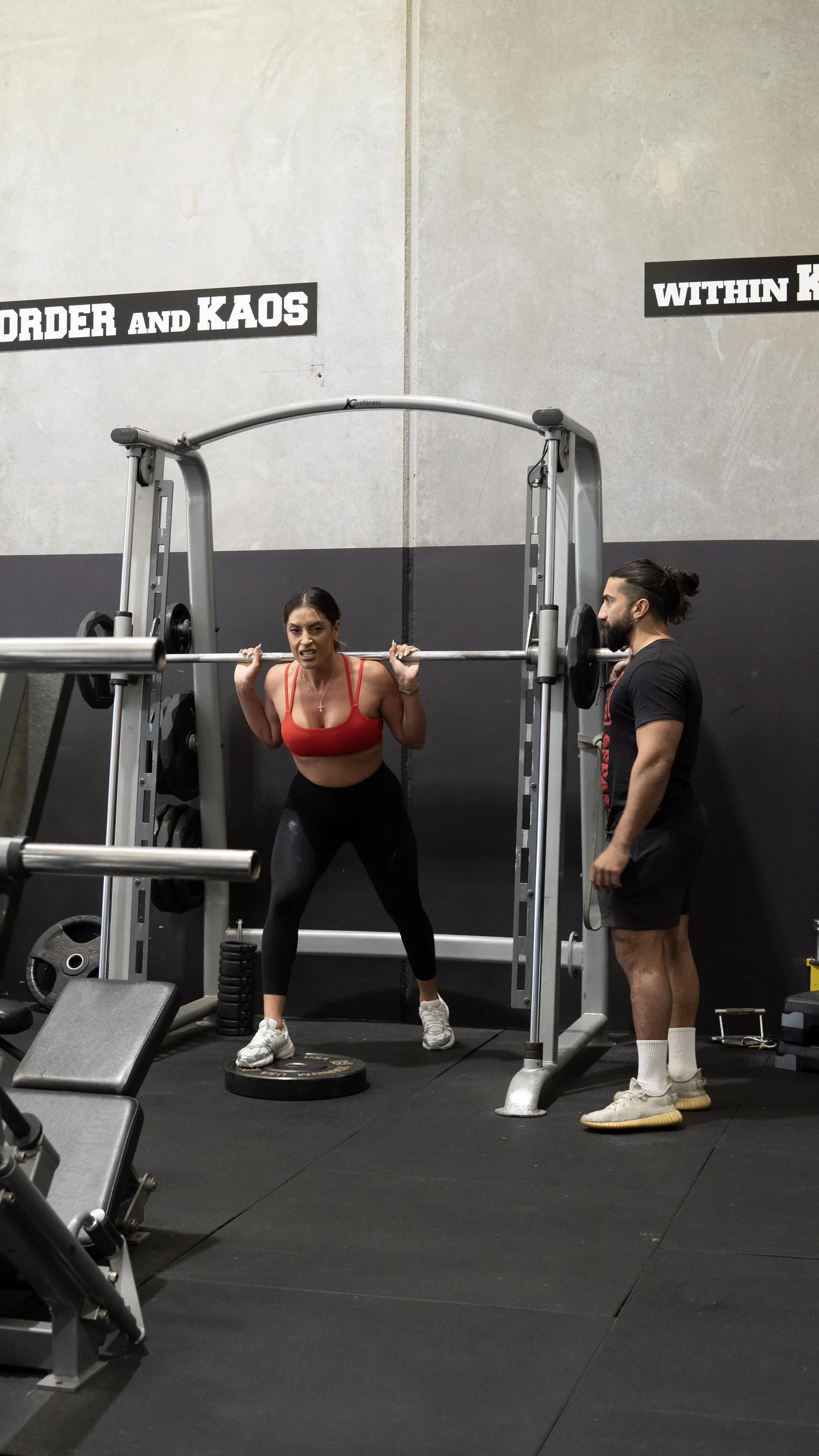 Member training at the smith machine at Kaos Fitness