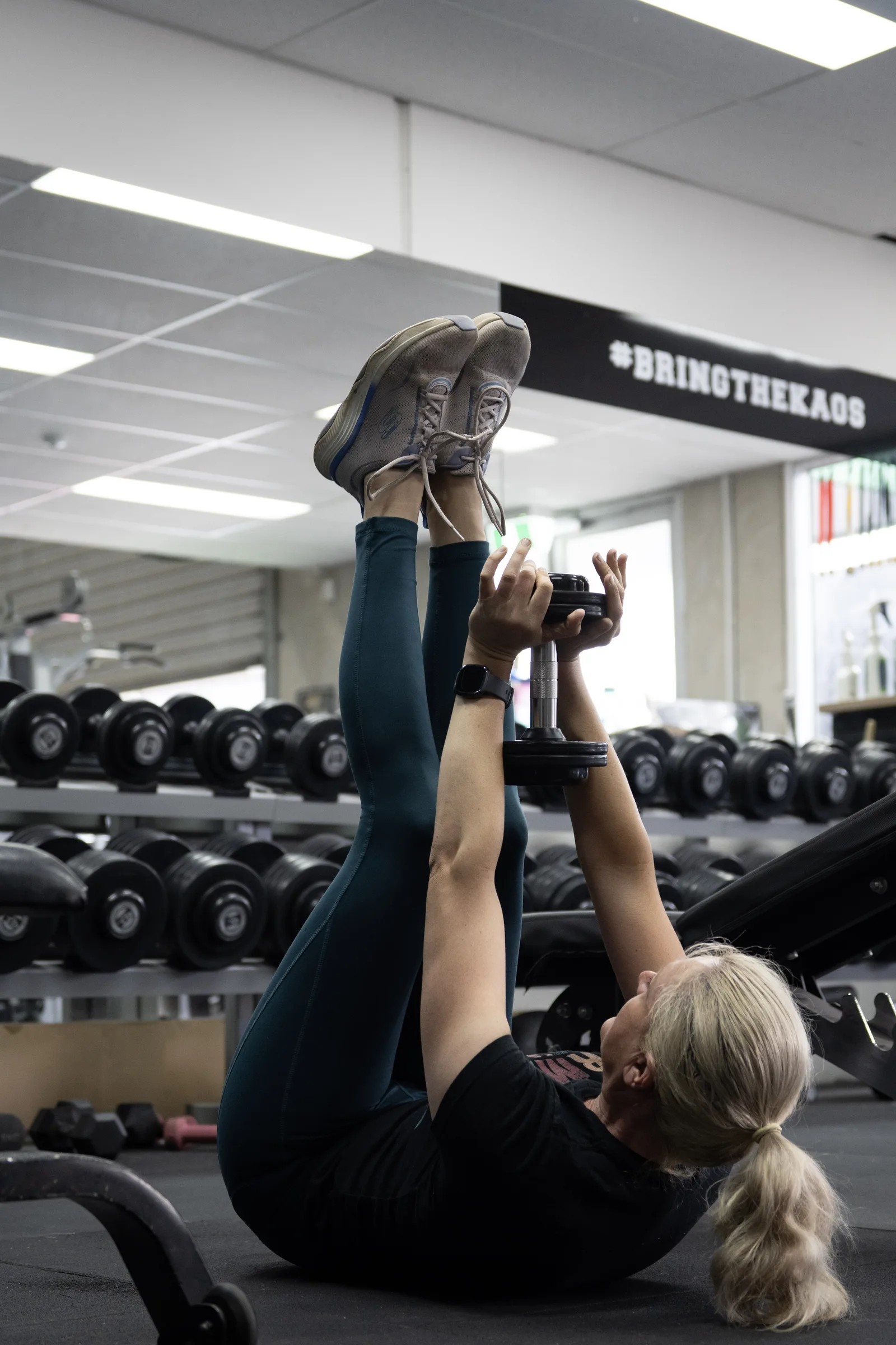Member squatting with a barbell at Kaos Fitness